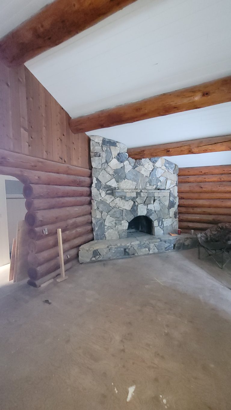 Log home interior with stone fireplace